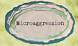 Microaggression typewritten word in ragged paper hole background - concept tattered illustration