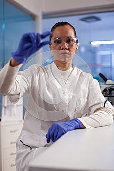 Microbiologist doctor looking at medical slice analyzing blood smaple