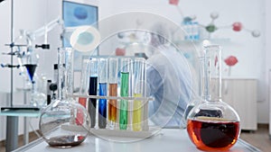 Microbiologist researcher doctor using medical transparent glassware mixing liquid solution