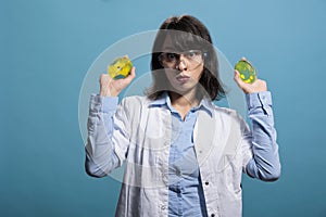 Microbiology laboratory expert holding petri dish plates with unknown bacteria