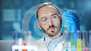 Microbiology male scientist conducting innovation experiment at futuristic digital lab background