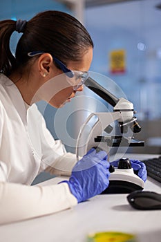 Microbiology specialist testing dna sample on microscope