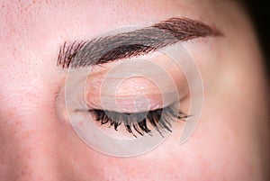 Microblading eyebrows, getting facial care and tattoo at beauty salon photo