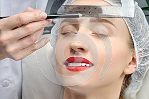 Microblading. Permanent makeup. Attractive woman getting facial care and tattoo