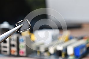 Microchip bios on tweezers, close-up