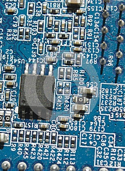 Microchip and components on blue electronic pcb closeup