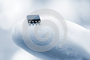 Microchip on a fingertip photo