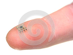 Microchip on a fingertip photo