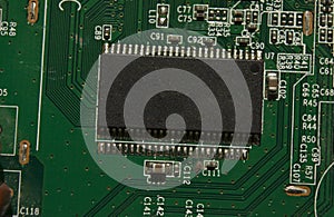 Microchip on green electronic pcb closeup