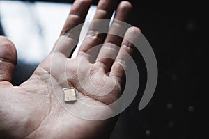 Microchip sim card, on hand, selective focus