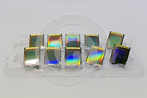 Ready-made microchips lying in a tray on the grey color surface. photo