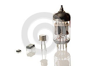 Microchips, transistor and radio tube isolated on white background photo