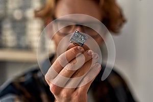 Microcircuit in hand of partial male IT engineer