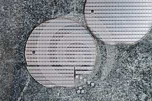 A microcircuit of a powerful Darlington transistor on a cut scribed semiconductor silicon multilayer wafer. Semiconductor chip is