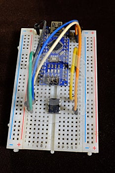A microcontroller development board on a breadboard
