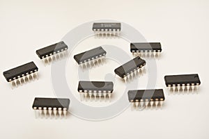 A microcontroller on a white background. An electronic chip in a plastic case