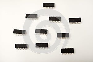A microcontroller on a white background. An electronic chip in a plastic case