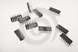 A microcontroller on a white background. An electronic chip in a plastic case