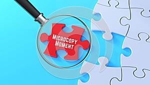 Microcopy Moment message magnified on red puzzle background in 3D text banner style