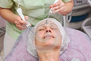 Microcurrent face treatment, adult woman.