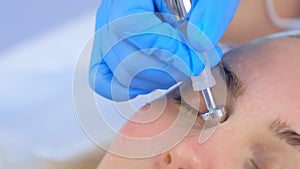 Microcurrent face treatment with hyaluronic acid gel for young woman, closeup.