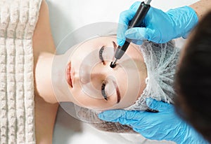 Microcurrent therapy for facial care. Cosmetologist doing face rejuvenation treatment