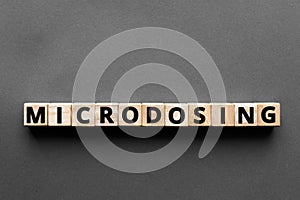 Microdosing - word from wooden blocks with letters photo