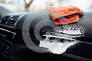 Microfiber cloth and foam on a car cockpit. Auto clean concept