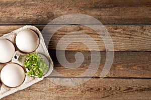 Microgreens in the eggshells on wooden background, easter concept