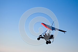Microlight aircraft in silhouette