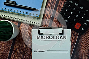 Microloan write on a paperwork isolated on office desk