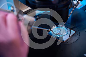 Micromanipulation of samples under a microscope in office photo