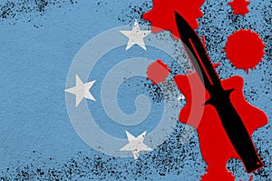 Micronesia flag and black tactical knife in red blood. Concept for terror attack or military operations with lethal outcome
