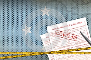 Micronesia flag and Health insurance claim form with covid-19 stamp. Coronavirus or 2019-nCov virus concept