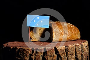 Micronesian flag on a stump with bread photo