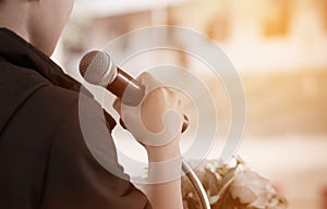 Microphone on abstract blurred of speech in seminar room or speaking conference hall light; computer bokeh background; Microphone