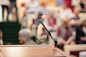 Microphone on abstract blurred of speech in seminar room or speaking conference hall light, Event Background photo