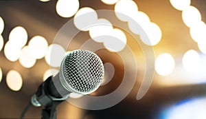 Microphone on abstract blurred of speech in seminar room or speaking conference hall light, Event concert bokeh background