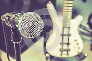 Microphone, blur electric bass background.