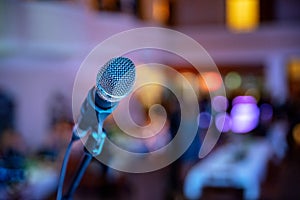 Microphone and blurred background. Karaoke party concept. Mic on stage. Stand up comedy. Music equipment.