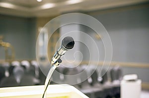 Microphone on blurred in seminar room or conference hall background