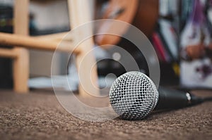 Microphone on carpeted floor with copy space.