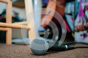 Microphone on carpeted floor with copy space.