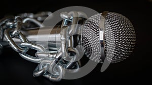 Microphone and chain. Freedom of the press is at risk concept - World press freedom day concept