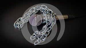 Microphone and chain. Freedom of the press is at risk concept - World press freedom day concept