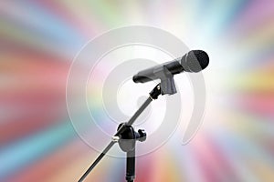 Microphone close up shot on blurred soft gradient zoom colorful effect light pink blue shade bokeh abstract background, party