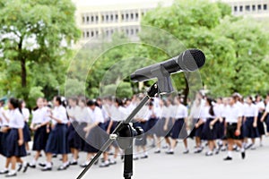 Microphone close up shot on Blurred Students high school walking for Background