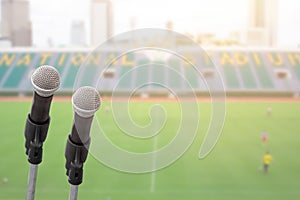 Microphone for commentator with sport football field photo