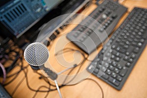 Microphone and computer keyboards on table at television studio