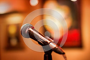 Microphone at a concert with a background in the form of pictures. Stage for performers with microphone stand for voice